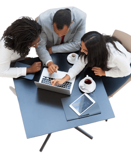 Three professionals sit around a table with a laptop, tablet, and coffee cups, collaborating and discussing work, highlighting teamwork, strategic planning, and innovative web development solutions at BrainPath Consults, a Lagos-based digital services company.